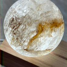 Load image into Gallery viewer, Clear Quartz 60mm Rutile and Golden Healer Inclusion Sphere
